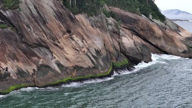 Aerial view of rocky cliffs and ocean at Praia do Leme Brazil.