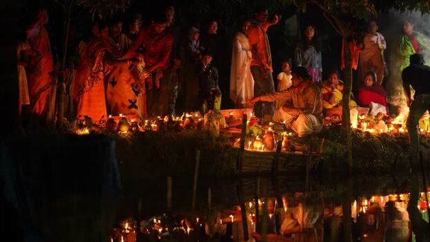 View of people lighting oil lamps during a festival in Bangladesh. View of people lighting oil lamps during a festival in Bangladesh.
