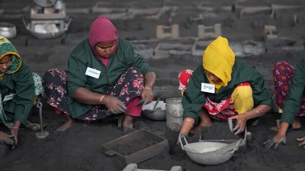 View of women working in a traditional foundry in Bogura Bangladesh.