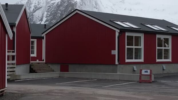 Aerial view of traditional red rorbuer cabins in Lofoten Norway.