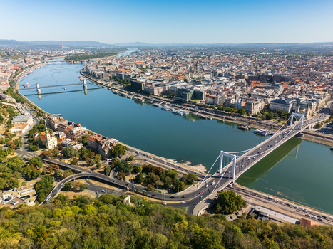 Aerial view of Budapest Hungary with Elisabeth Bridge over the Danube Chain Bridge Parliament riverside cruise boats and dense historic city center in summer. Aerial view of Budapest Hungary with Elisabeth Bridge over the Danube Chain Bridge Parliament riverside cruise boats and dense historic city center in summer.