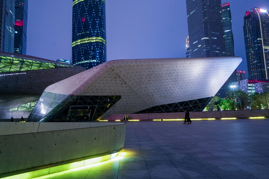 Guangzhou Guangdong Province China 24 February 2024 View of the futuristic Guangzhou Opera House at dusk with illuminated glass and steel architecture and towering skyscrapers. Guangzhou Guangdong Province China 24 February 2024 View of the futuristic Guangzhou Opera House at dusk with illuminated glass and steel architecture and towering skyscrapers.