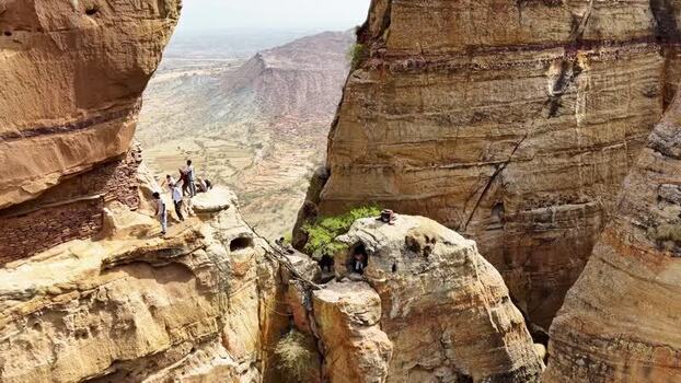 Aerial view of people on the steep cliffs of Abune Yemata Ethiopia. Aerial view of people on the steep cliffs of Abune Yemata Ethiopia.