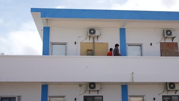 View of people on a balcony in San Jose Northern Mariana Islands. View of people on a balcony in San Jose Northern Mariana Islands.