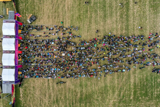 Herzogenaurach Germany 25 July 2025 Aerial view of the Open Beatz Festival with a large crowd of people queuing at the entrance gate on a green field. Herzogenaurach Germany 25 July 2025 Aerial view of the Open Beatz Festival with a large crowd of people queuing at the entrance gate on a green field.