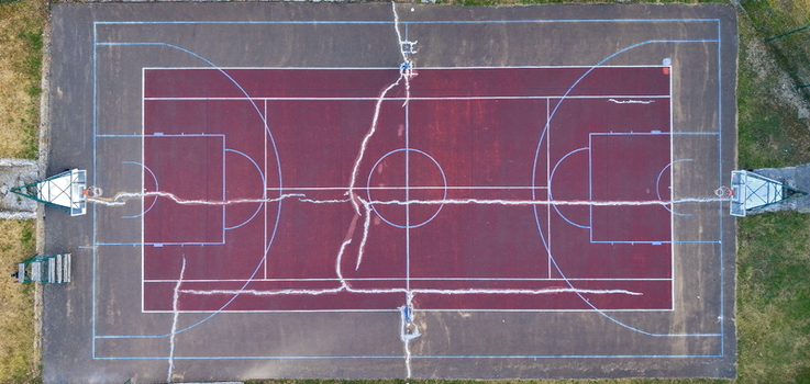 Aerial view of the basketball court at Brzece Sports Center featuring visible cracks across the surface in Brzece Rasina District Serbia.
