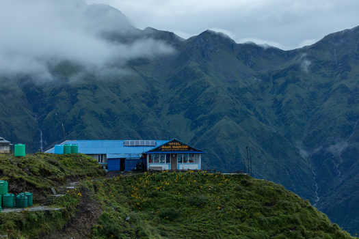 Pokhara Gandaki Province Nepal 27 August 2026 View of Hotel Magic Mountain nestled on a lush green hillside along the Mardi Himal Trek surrounded by misty mountains.