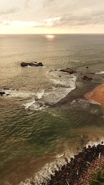Aerial view of waves crashing on the coast at sunset Sri Lanka.