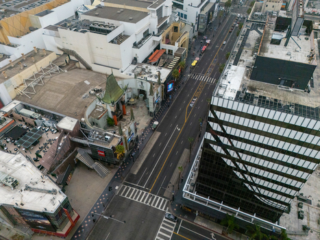 Aerial view of the Hollywood Walk of Fame with its iconic stars on the sidewalk surrounded by urban buildings and city streets in Los Angeles California United States.
