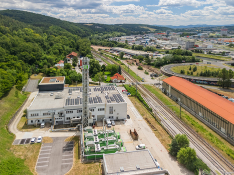 Aerial view of the STEFE Banska Bystrica heating plant in Radvan with industrial buildings a tall chimney solar panels and railway tracks in Banska Bystrica Slovakia. Aerial view of the STEFE Banska Bystrica heating plant in Radvan with industrial buildings a tall chimney solar panels and railway tracks in Banska Bystrica Slovakia.