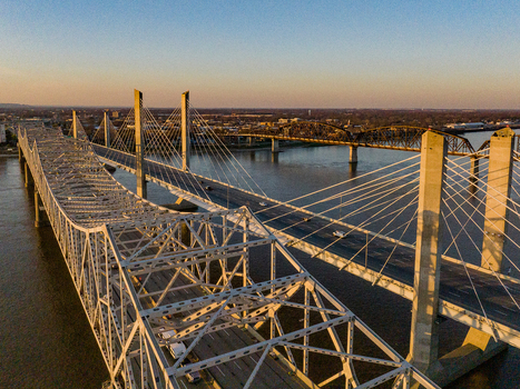Aerial view of the Abraham Lincoln Bridge and John F. Kennedy Memorial Bridge spanning the Ohio River during sunset in Louisville Kentucky United States. Aerial view of the Abraham Lincoln Bridge and John F. Kennedy Memorial Bridge spanning the Ohio River during sunset in Louisville Kentucky United States.