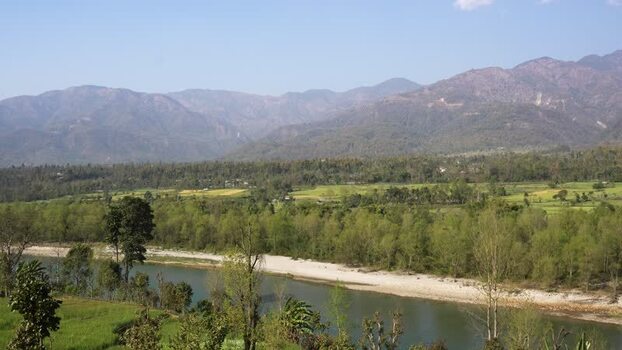 View of a wide river and mountains Nepal.