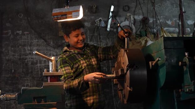 View of a young boy operating a lathe machine in Bogura Bangladesh.