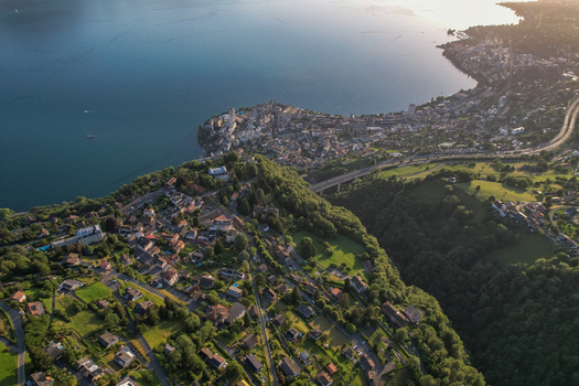 Aerial view of the hillside village of Glion overlooking Lake Geneva with lush greenery and residential houses in Montreux Vaud Switzerland. Aerial view of the hillside village of Glion overlooking Lake Geneva with lush greenery and residential houses in Montreux Vaud Switzerland.