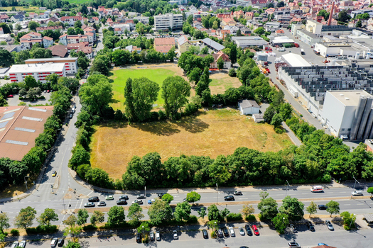 Aerial view of the SpVgg Jahn Forchheim Jugendabteilung sports grounds surrounded by lush trees and urban buildings in Forchheim Bayern Germany. Aerial view of the SpVgg Jahn Forchheim Jugendabteilung sports grounds surrounded by lush trees and urban buildings in Forchheim Bayern Germany.