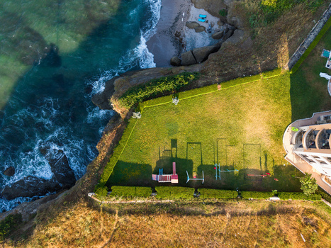 Aerial view of Lozenets Northern Cross featuring a playground on a green lawn situated on a cliff edge overlooking the sea in Lozenets Burgas Bulgaria. Aerial view of Lozenets Northern Cross featuring a playground on a green lawn situated on a cliff edge overlooking the sea in Lozenets Burgas Bulgaria.