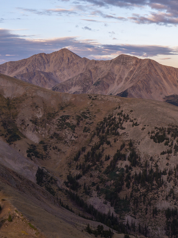 Aerial view of Missouri Mountain and the rugged landscape of Missouri Gulch Trail at sunrise with coniferous trees and rocky slopes in Buena Vista Colorado United States.