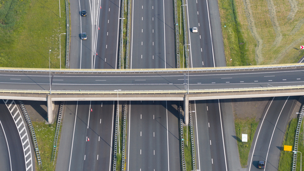Aerial view of Knooppunt Oudenrijn highway interchange with multiple lanes cars driving and green verges in Utrecht Utrecht Netherlands. Aerial view of Knooppunt Oudenrijn highway interchange with multiple lanes cars driving and green verges in Utrecht Utrecht Netherlands.