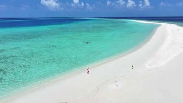 Aerial view of a tropical sandbank and turquoise waters in Maldives. Aerial view of a tropical sandbank and turquoise waters in Maldives.