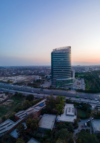 Aerial view of Arfa Karim Tower and the surrounding urban landscape with a busy road and rooftops at sunset in Lahore Punjab Pakistan. Aerial view of Arfa Karim Tower and the surrounding urban landscape with a busy road and rooftops at sunset in Lahore Punjab Pakistan.