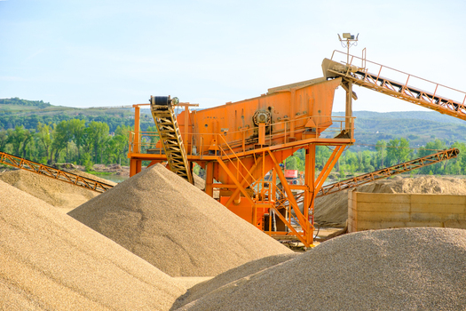 View of industrial gravel processing machinery with conveyor belts and large sand piles under a clear sky Novi Sad Vojvodina Serbia. View of industrial gravel processing machinery with conveyor belts and large sand piles under a clear sky Novi Sad Vojvodina Serbia.