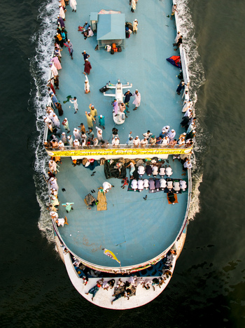 Dhaka Bangladesh 04 April 2026 Aerial view of a ferry brimming with people creating a vibrant mosaic against the dark waters of the river. Dhaka Bangladesh 04 April 2026 Aerial view of a ferry brimming with people creating a vibrant mosaic against the dark waters of the river.