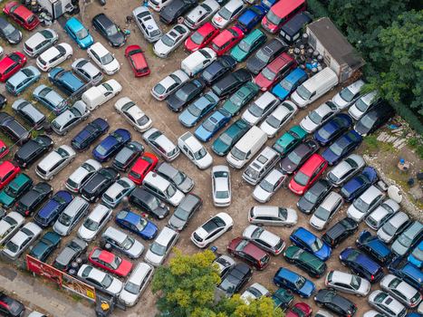 Aerial view of a crowded parking lot filled with numerous cars parked in rows on an asphalt surface in Berlin Berlin Germany.