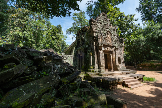 View of the ancient stone temple of Ta Prohm with moss covered ruins intricate carvings and towering jungle trees in Krong Siem Reap Siem Reap Province Cambodia. View of the ancient stone temple of Ta Prohm with moss covered ruins intricate carvings and towering jungle trees in Krong Siem Reap Siem Reap Province Cambodia.