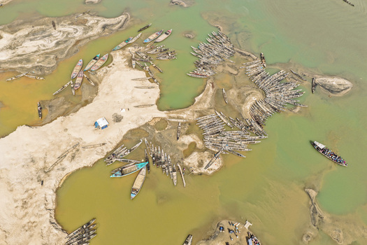Aerial view of Jadukata River with numerous wooden boats moored along the sandy banks and shallow river waters in Sunamganj Sylhet Division Bangladesh. Aerial view of Jadukata River with numerous wooden boats moored along the sandy banks and shallow river waters in Sunamganj Sylhet Division Bangladesh.