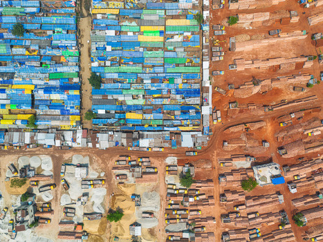 Aerial view of a striking contrast between the blue and green buildings juxtaposed against the earthy tones of brick piles Dhaka Dhaka Division Bangladesh. Aerial view of a striking contrast between the blue and green buildings juxtaposed against the earthy tones of brick piles Dhaka Dhaka Division Bangladesh.