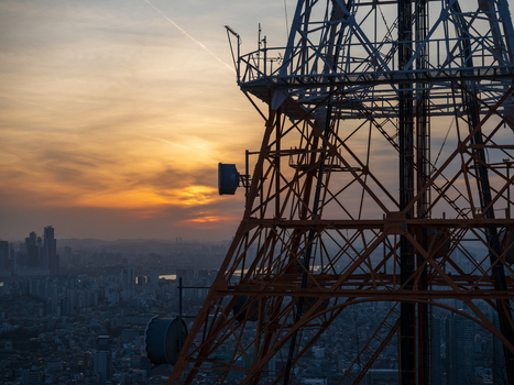 Aerial view of a telecommunications tower overlooking the city skyline of Busan during a vibrant sunset in Busan Busan South Korea. Aerial view of a telecommunications tower overlooking the city skyline of Busan during a vibrant sunset in Busan Busan South Korea.