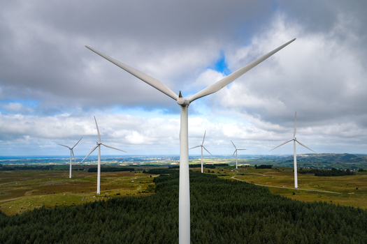Aerial view of the Hog Jaeren wind farm with multiple wind turbines set against a cloudy sky over the green landscape of Ha Municipality Rogaland Norway.