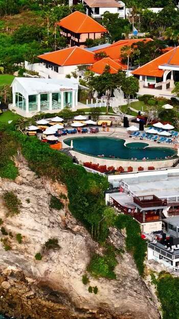 Aerial view of cliffside resort with pool in Bali Indonesia.