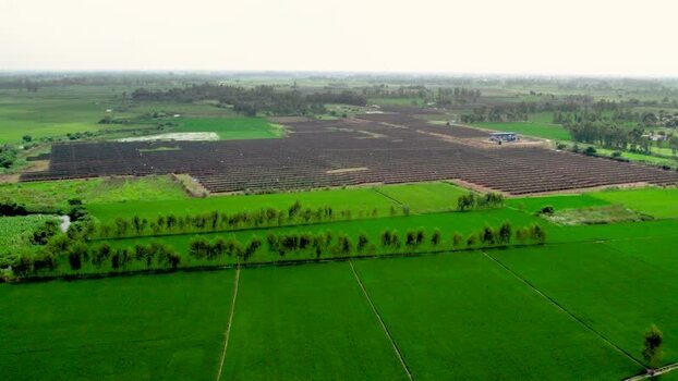 Aerial view of a solar farm in a rural field India.