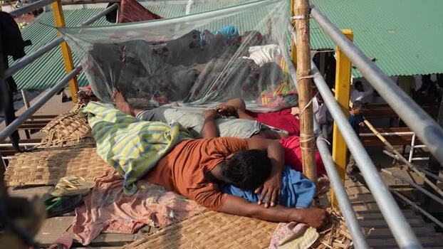 View of people sleeping on a deck at Sadarghat Bangladesh.