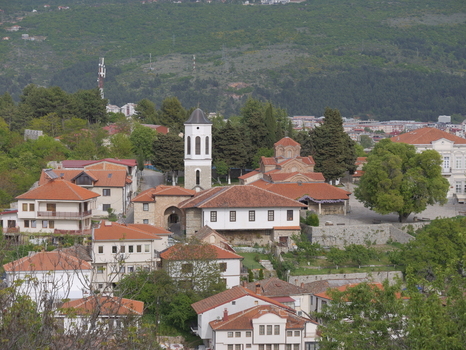 View of the Church of the Virgin Mary Peribleptos with its bell tower and terracotta roofs surrounded by historic houses and trees in Ohrid Municipality of Ohrid North Macedonia. View of the Church of the Virgin Mary Peribleptos with its bell tower and terracotta roofs surrounded by historic houses and trees in Ohrid Municipality of Ohrid North Macedonia.