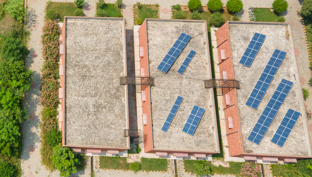 Lahore Pakistan 08 September 2026 Aerial view of a government office data canter complex featuring flat rooftops equipped with solar panels surrounded by landscaped greenery and paved walkways.