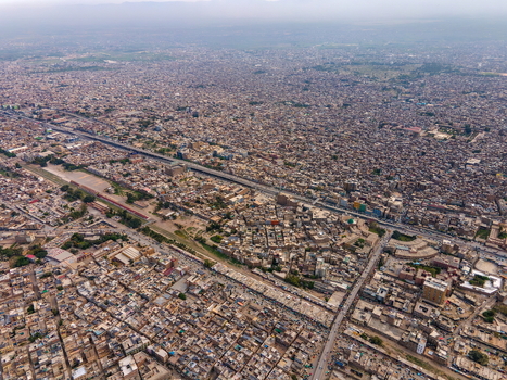 Aerial view of Bala Hisar Fort surrounded by the dense urban sprawl historic buildings and bustling streets of Peshawar Khyber Pakhtunkhwa Pakistan.