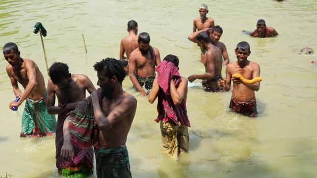 View of men bathing in a river in Natore Bangladesh. View of men bathing in a river in Natore Bangladesh.