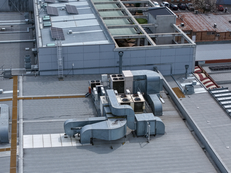 Melbourne VIC Australia 25 September 2026 Aerial view of industrial rooftop with HVAC ventilation systems and solar panels.