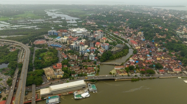 Aerial view of the Atal Setu bridge spanning the Mandovi River with the cityscape of Panaji lush greenery and modern buildings in Panaji Goa India.