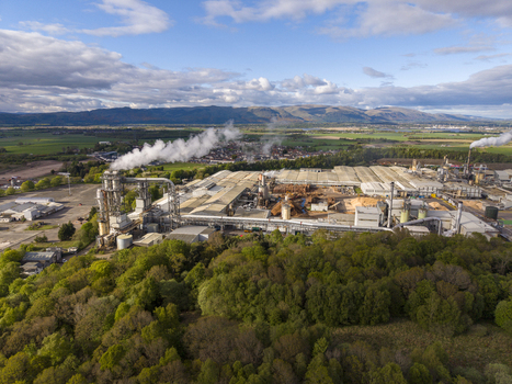 Cowie United Kingdom 06 May 2026 Aerial view of a large industrial timber processing plant with smoking chimneys surrounded by green forests and rolling hills. Cowie United Kingdom 06 May 2026 Aerial view of a large industrial timber processing plant with smoking chimneys surrounded by green forests and rolling hills.
