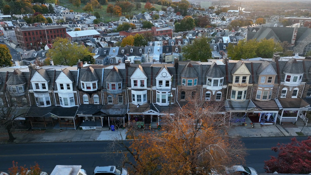 Aerial view of a row of historic Victorian style houses with porches and autumn foliage along a residential street in Reading Pennsylvania United States. Aerial view of a row of historic Victorian style houses with porches and autumn foliage along a residential street in Reading Pennsylvania United States.