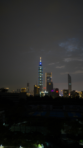 Taipei City Taiwan 21 February 2026 Aerial view of Taipei 101 illuminated at night rising above the surrounding urban skyline under a dark cloudy sky. Taipei City Taiwan 21 February 2026 Aerial view of Taipei 101 illuminated at night rising above the surrounding urban skyline under a dark cloudy sky.