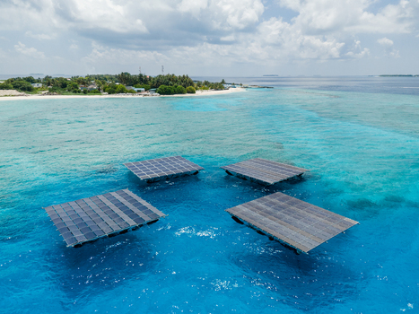 Aerial view of the SolarSea floating solar power plant platforms on turquoise waters near the tropical island of Dharavandhoo Baa Atoll Maldives. Aerial view of the SolarSea floating solar power plant platforms on turquoise waters near the tropical island of Dharavandhoo Baa Atoll Maldives.