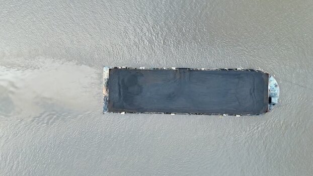 Aerial view of coal barge on river in Indonesia.