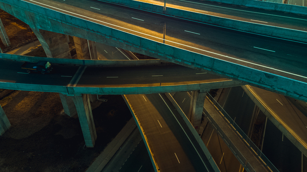 Aerial view of the multi level Pokuase Interchange with concrete flyovers road markings and a vehicle driving at night in Ga North Municipal Greater Accra Region Ghana. Aerial view of the multi level Pokuase Interchange with concrete flyovers road markings and a vehicle driving at night in Ga North Municipal Greater Accra Region Ghana.