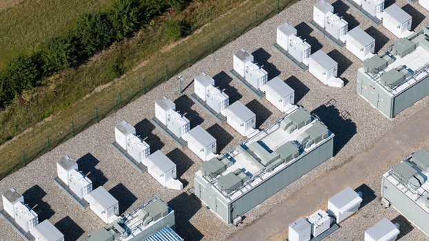 Aerial view of Pelham Storage Limited featuring rows of white battery energy storage containers on a gravel site in Bishop s Stortford England United Kingdom. Aerial view of Pelham Storage Limited featuring rows of white battery energy storage containers on a gravel site in Bishop s Stortford England United Kingdom.