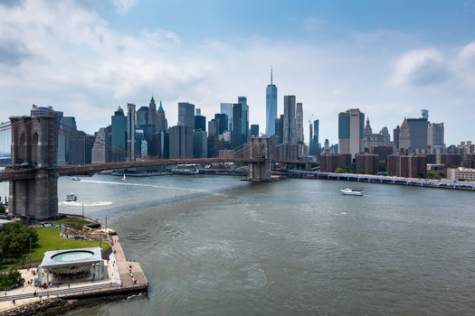 New York United States 11 August 2021 Aerial view of the Brooklyn Bridge spanning the East River with the Manhattan skyline in the background under a blue sky.
