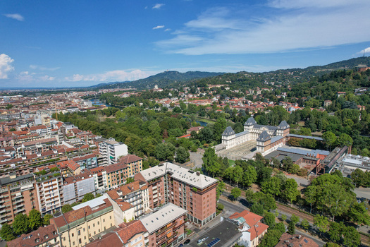 Aerial view of Castello del Valentino surrounded by lush greenery and the Po river under a clear blue sky in Torino Piemonte Italy. Aerial view of Castello del Valentino surrounded by lush greenery and the Po river under a clear blue sky in Torino Piemonte Italy.